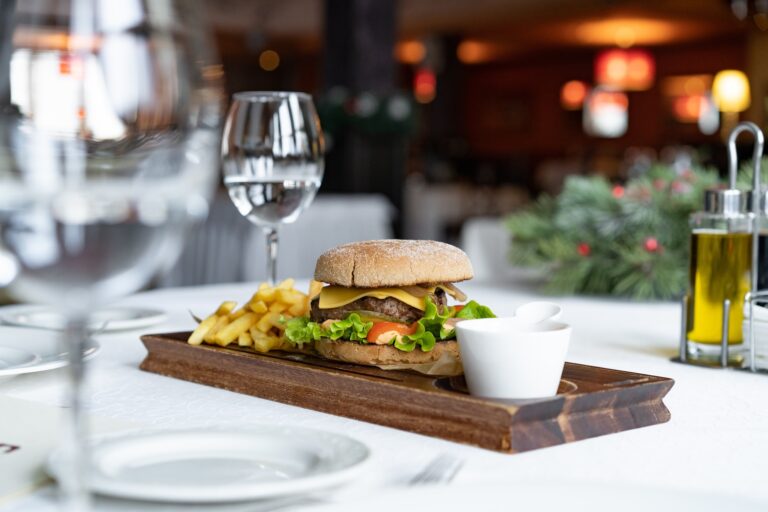 A delicious hamburger with lettuce, tomato, and cheese served with fries.