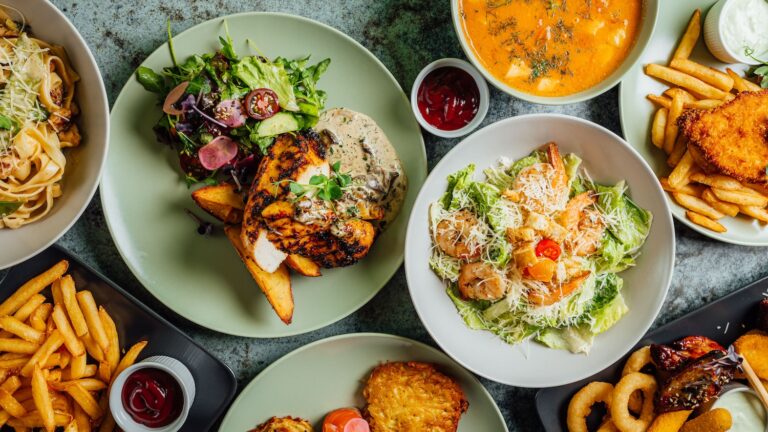 A variety of delicious dishes including grilled chicken, pasta, salad, and fries.